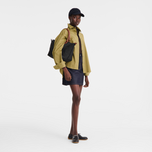 Load image into Gallery viewer, person holding a bag with the straps over her shoulder and the bag under her arm