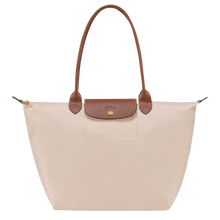 Load image into Gallery viewer, Paper cream colored back with leather to landel and leather flat at the center top of the bag Le Pliage Original shoulder bag with leather accents and gold hardware