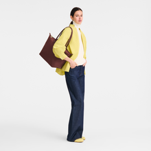 Load image into Gallery viewer, person holding the Longchamp Le Pliage One L Shoulder Bag Handbag in Burgundy under her shoulder