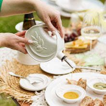 Load image into Gallery viewer, person using Vietri Luna Olive Oil Bottle