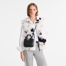 Load image into Gallery viewer, person wearing Longchamp Le Roseau Leather Top Handle Handbag X-Small Black as a crossbody