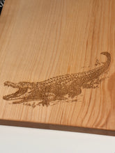 Load image into Gallery viewer, A close-up of a light natural wood surface with a detailed brown engraved or burned animal silhouette, likely a bird, on the right side.