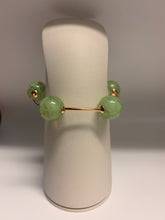 Load image into Gallery viewer, Green jade bracelet on a white stand with a neutral background