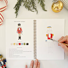 Load image into Gallery viewer, person painting the Nutcracker in the Nutcracker Watercolor Workbook