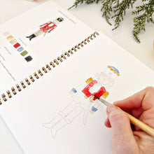 Load image into Gallery viewer, person painting the Nutcracker in the Nutcracker Watercolor Workbook