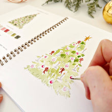 Load image into Gallery viewer, person painting the Christmas tree in the Nutcracker Watercolor Workbook