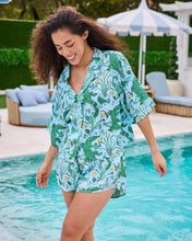 Load image into Gallery viewer, woman in the Printfresh Gator Grove Eco Satin Sweet Dreams Set in Blue Lagoon short sleeve button down top and short shorts