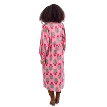 Load image into Gallery viewer, woman wearing long pink dress with long sleeves red and green print pattern photographed from the back