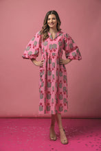 Load image into Gallery viewer, woman wearing long pink dress with long sleeves red and green print pattern