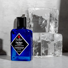 Load image into Gallery viewer, Bottle of Jack Black Post Shave Cooling Gel next to two ice cubes