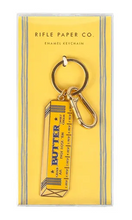 Load image into Gallery viewer, Butter container keychain on a yellow card with 'Rifle Paper Co.' branding