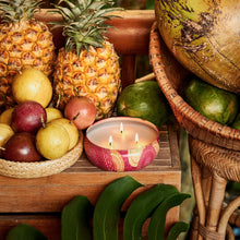 Load image into Gallery viewer, Voluspa Nāpali Passion Fruite 3-Wick Tin Candle set next to tropical fruit