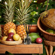 Load image into Gallery viewer, Voluspa Napali Passion Fruit Reed Diffuser next to tropical fruit