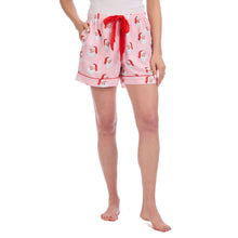 Load image into Gallery viewer, pink shorts with red drawstring ribbon. Shorts are printed with a images of santa's face