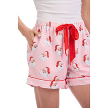 Load image into Gallery viewer, pink shorts with red drawstring ribbon. Shorts are printed with a images of santa's face