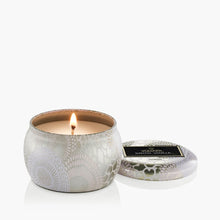 Load image into Gallery viewer, Voluspa Santal Vanille Candle - Mini Tin 4oz with candle lit and lid next to it