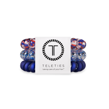 Load image into Gallery viewer, three hair ties, one blue, one white with blue glitter, one red white and blue