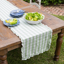 Load image into Gallery viewer, Juliska Gingham Ruffle 18" x 90" Table Runner on a wood table outside