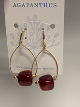 Load image into Gallery viewer, Gold hoop earrings with red beads on a 'Agapanthus' branded card.