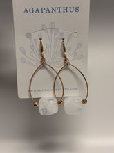 Load image into Gallery viewer, Gold hoop earrings with a clear stone on a 'Agapanthus' branded card.