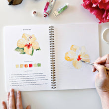 Load image into Gallery viewer, person painting a hibiscus flower in the Tropical Watercolor workbook