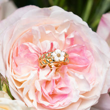 Load image into Gallery viewer, wine ring with mother of pearl flower set in the center of a rose
