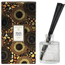 Load image into Gallery viewer, Voluspa Baltic Amber Reed Diffuser box and clear jar with black reeds