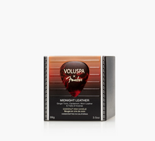 Load image into Gallery viewer, Voluspa x Fender Midnight Leather coconut wax candle in a rectangular box with a guitar-pick-shaped red label, shown on a clean white background.