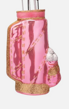 Load image into Gallery viewer, A pink glass golf ball ornament with gold glitter trim and a small white-and-gray golf ball detail, shown against a plain light background.