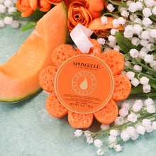 Load image into Gallery viewer, yellow flower shaped sponge with white ribbon next to lily of the vally flowers, roses and cantaloupe