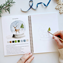 Load image into Gallery viewer, person painting a snowglobe in the Winter Watercolor Workbook