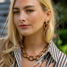 Load image into Gallery viewer, person wearing Capucine de Wulf Earth Goddess Link Drop Earrings Gold and Teak earrings and necklace