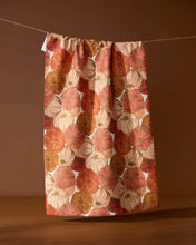 Load image into Gallery viewer, Geometry Tendril Tea Towel handing from twine with a stack of clean dishes next to it