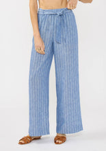 Load image into Gallery viewer, person wearing the Striped Wide Leg Pant with Side Pockets view showing long wide leg pants with subtle blue and white stripes and a tied matching fabric belt