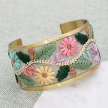 Load image into Gallery viewer, Embroidered floral cuff bracelet on a textured surface