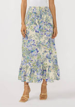 Load image into Gallery viewer, Convertible Smocked Skirt with a blue and pale green floral pattern against a cream colored background. The waist of the skirt is smocked