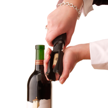 Load image into Gallery viewer, person showing how to remove a cork from the Legacy Cork Pops