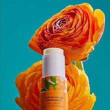 Load image into Gallery viewer, Wellbeing Solid Perfume Neroli with an orange flower