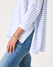 Load image into Gallery viewer, person wearing Mersea Catalina Slub Stripe Ringer Tee white and light blue paired with blue jeans showing 3/4 sleeves
