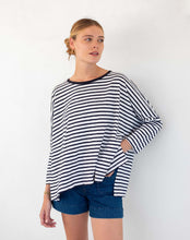 Load image into Gallery viewer, person wearing Mersea Catalina Slub Stripe Ringer Tee white and navy paired with blue shorts