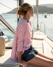 Load image into Gallery viewer, person on a boat wearing Mersea Catalina Slub Stripe Ringer Tee white and pink paired with shorts