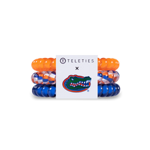 Load image into Gallery viewer, Three hair ties, one orange one blue and one orange, white and blue