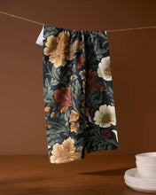 Load image into Gallery viewer, Geometry Classic Floral Tea Towel handing from twine with a stack of clean dishes next to it
