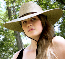 Load image into Gallery viewer, woman wearing the tan hat with wide brim 

