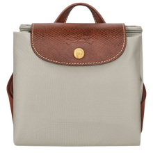 Load image into Gallery viewer, Longchamp Le Pliage Original Backpack - Medium in Pebble gray folded and snapped closed for travel 
