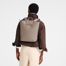 Load image into Gallery viewer, person with the Longchamp Le Pliage Xtra Leather Backpack medium in Turtledove in their back
