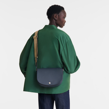 Load image into Gallery viewer, person wearing a Longchamp Épure Medium Leather Crossbody Bag in Navy leather with tan crossbody stripe 
