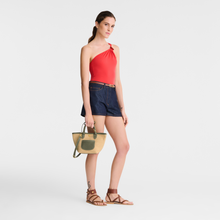 Load image into Gallery viewer, person holding an x-small Longchamp Le Pliage Collection Crossbody Basket Bag
