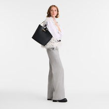 Load image into Gallery viewer, person holding the Longchamp Le Roseau Leather Hobo Shoulder Bag  Medium Black
