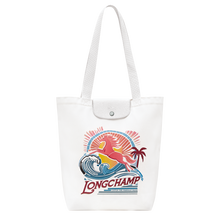 Load image into Gallery viewer, white bag with colorful horse and ocean waves logo
